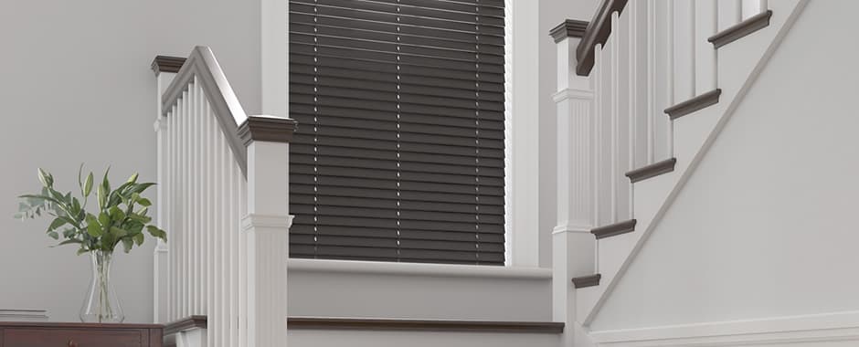 Dark wooden blinds on staircase