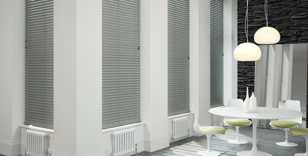 Grey faux wood venetian blinds in long windows