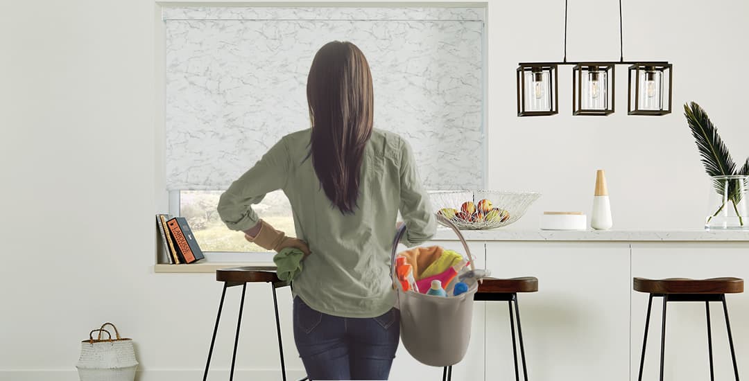 Woman cleaning window blinds