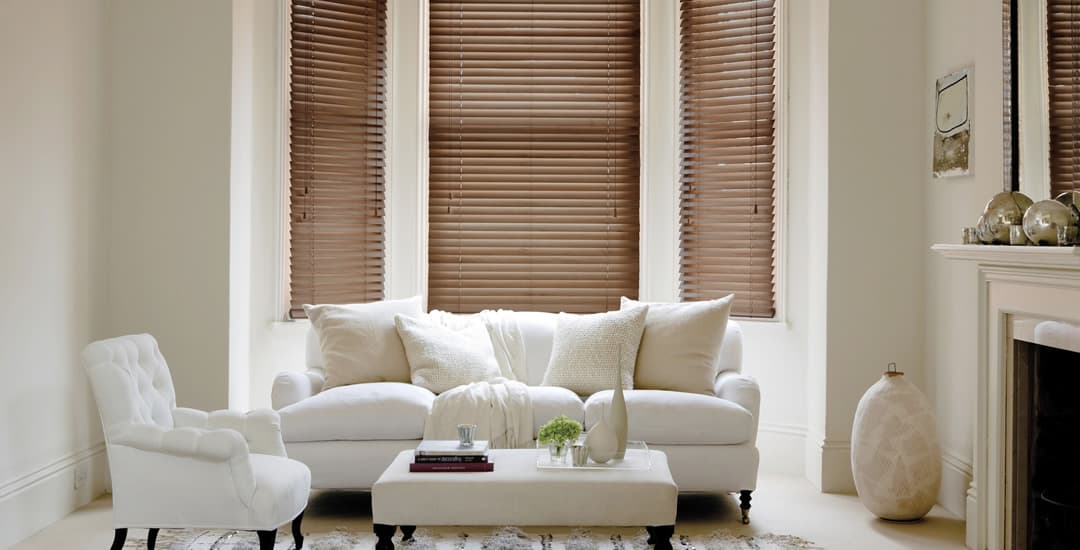 Dark wooden blinds in bay window