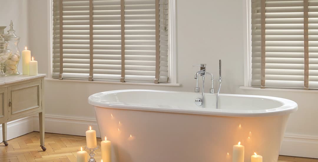 Faux wood blinds in bathroom with candles