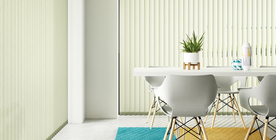 Pale green vertical blinds in dining room