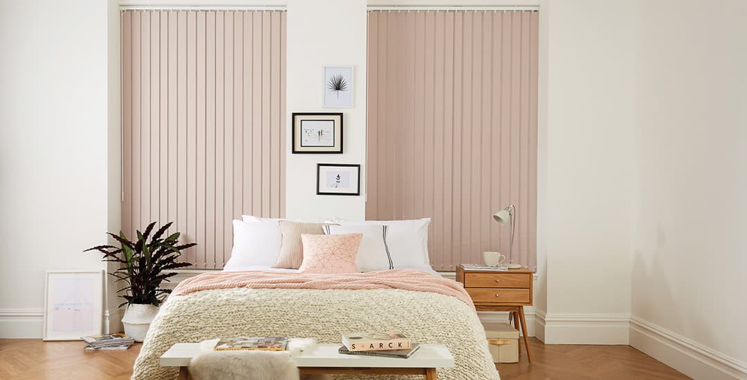 Pink thermal blackout vertical blinds in bedroom