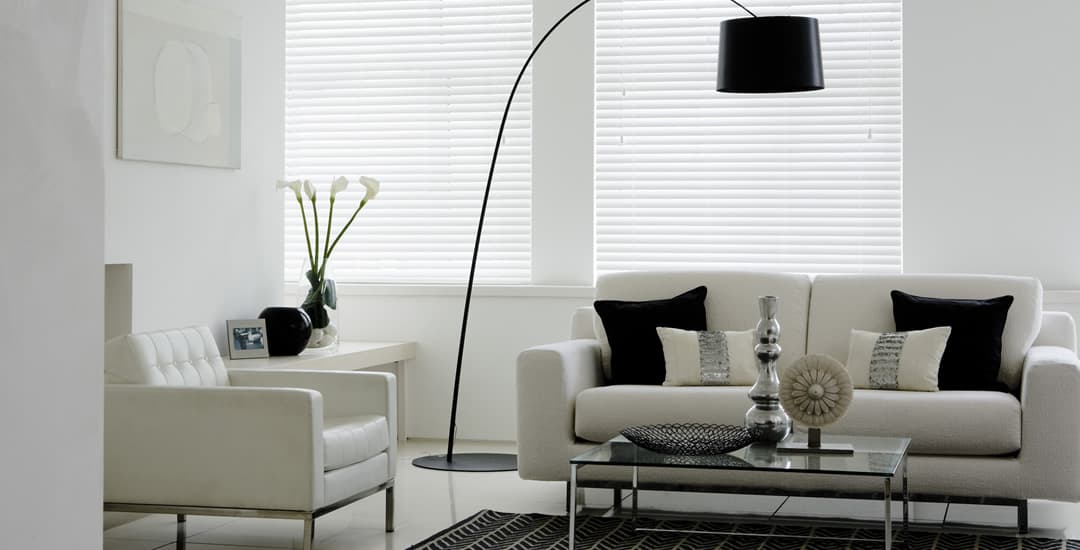 White faux wood blinds in living room