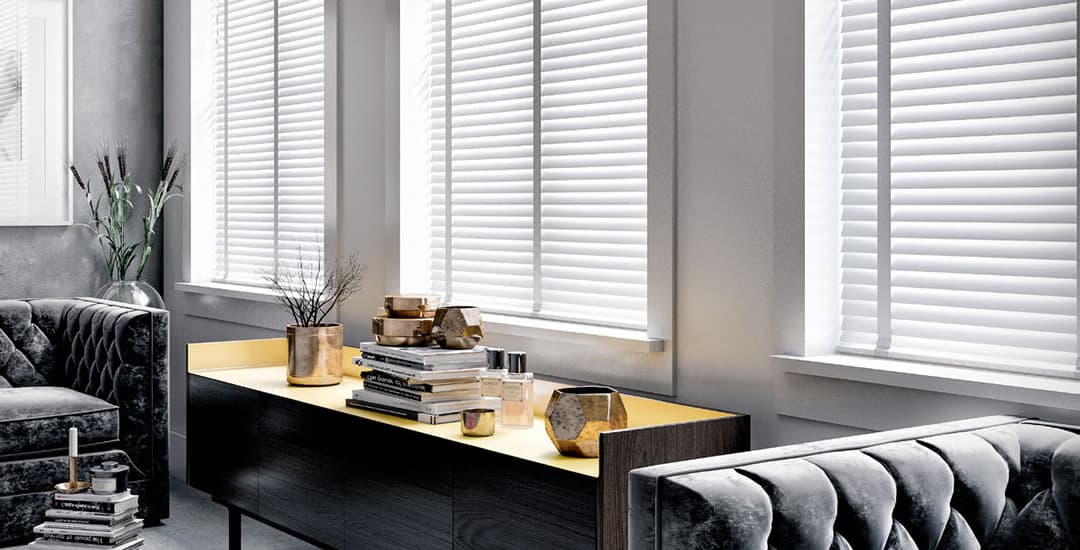 White faux wood blinds with tapes in sitting room