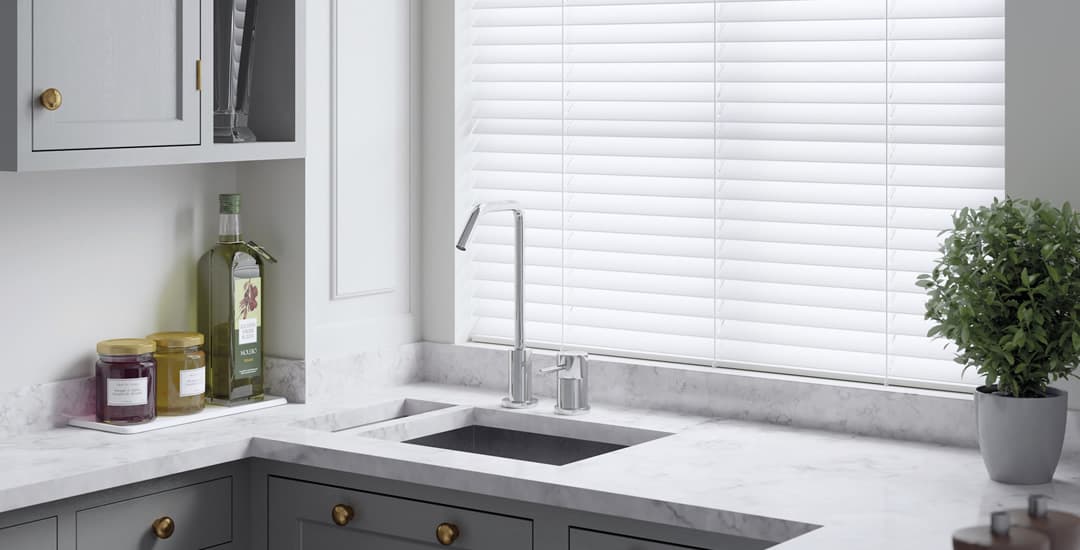 White fine grain faux wood blinds in kitchen