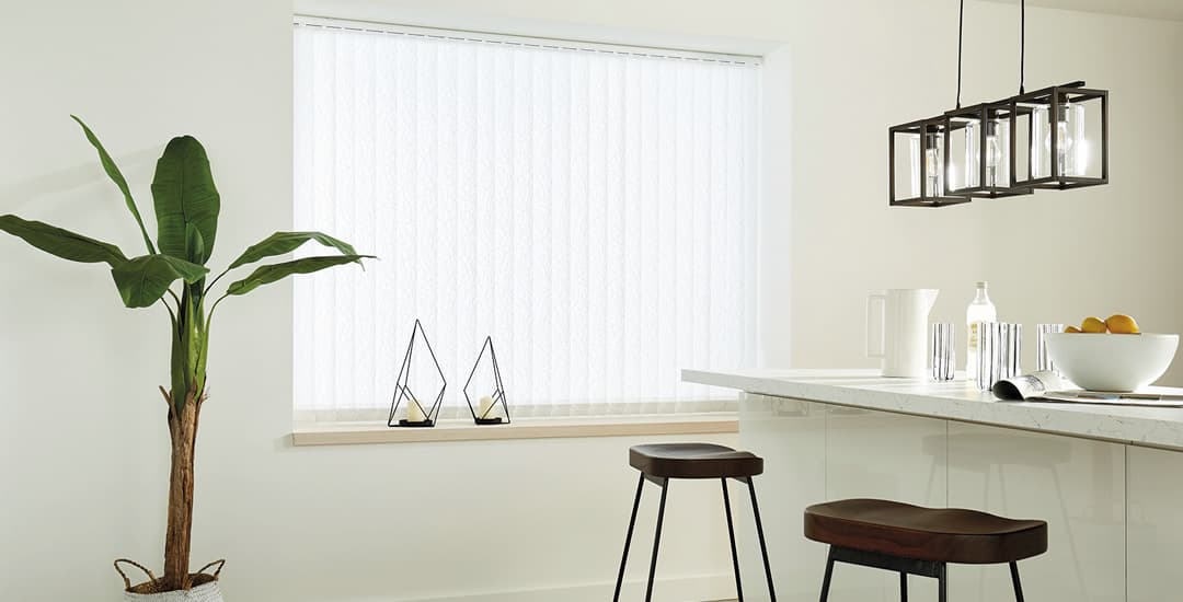 White vertical blinds in modern kitchen