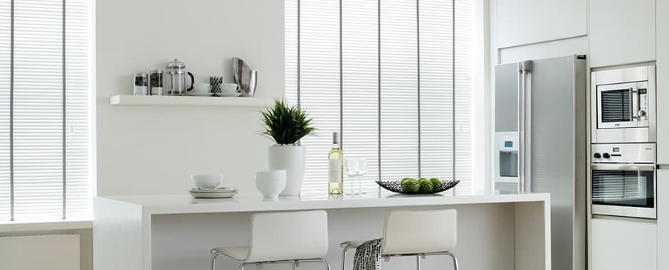 White wooden blinds with tapes in white kitchen