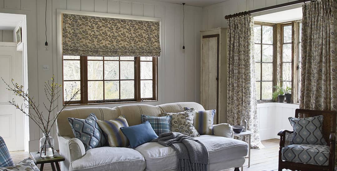Leaf patterned roman blinds in cottage lounge