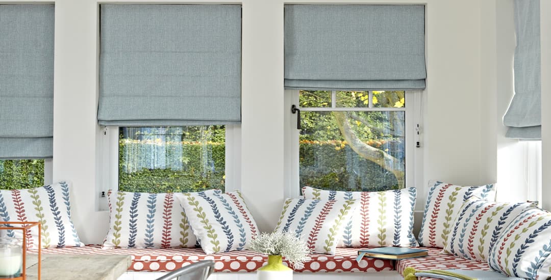 Luxury blue roman blinds in garden room