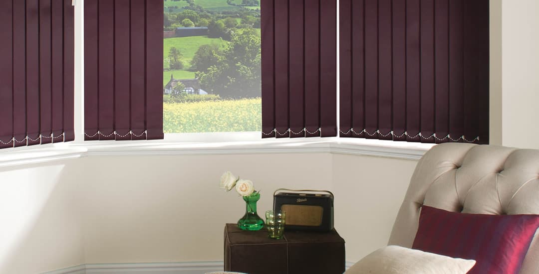 Purple vertical blinds in lounge bay window
