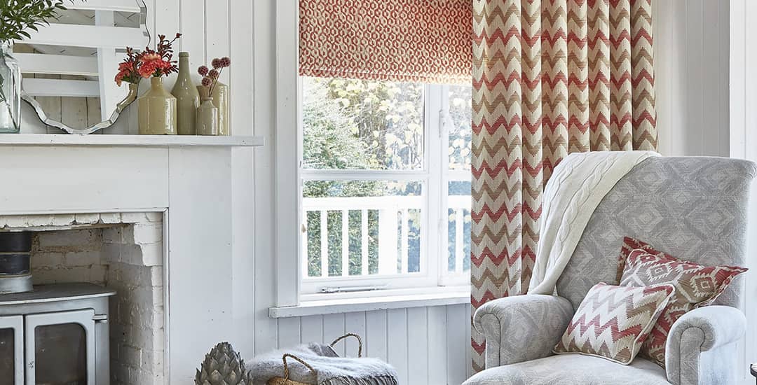 Red patterned roman blind in white living room