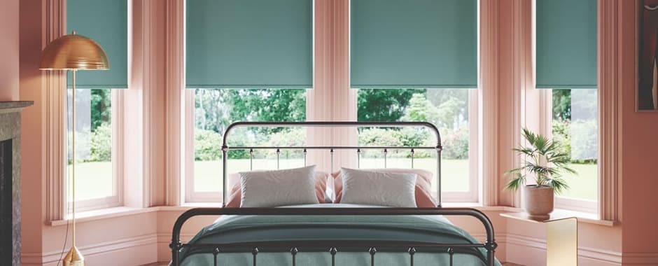 Green blackout roller blinds in a luxury colourful bedroom