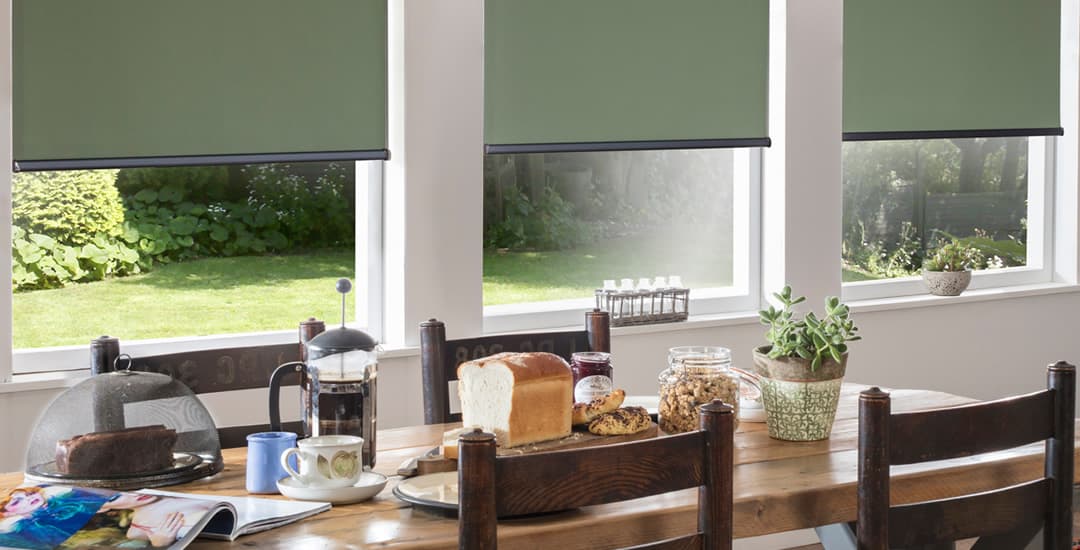 Green roller blinds in dining room