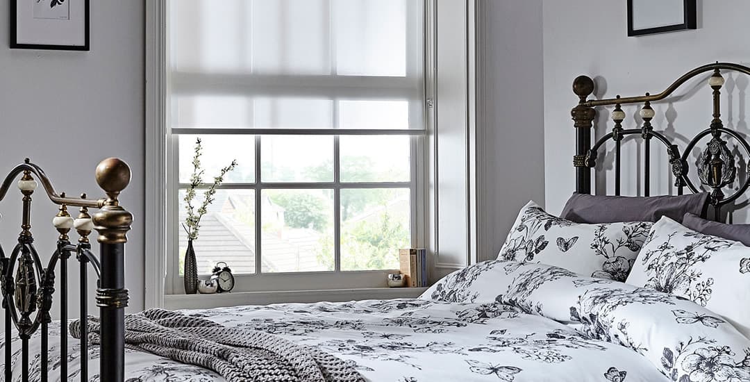 White dim out bedroom roller blinds