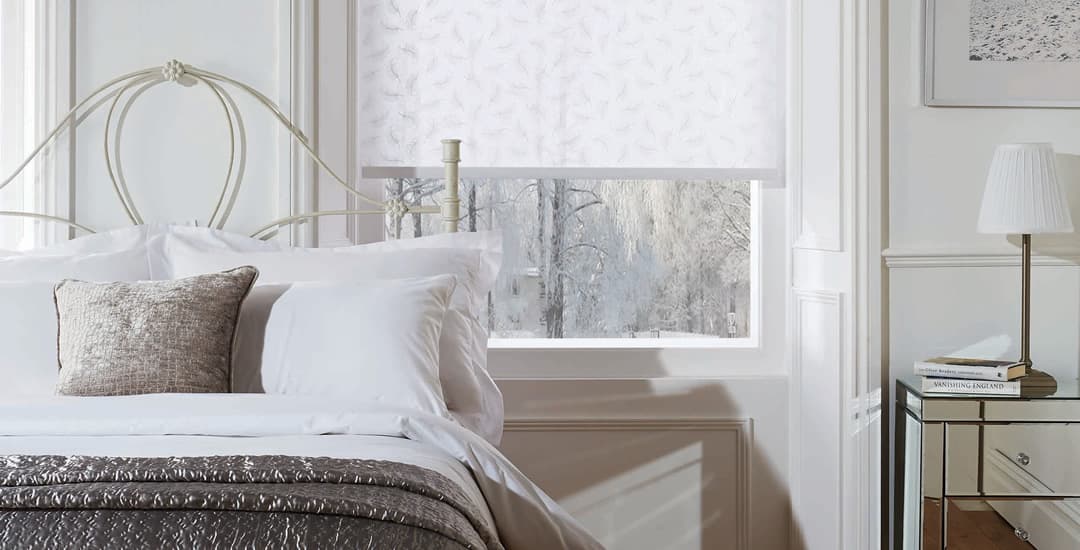 White roller blinds in bedroom