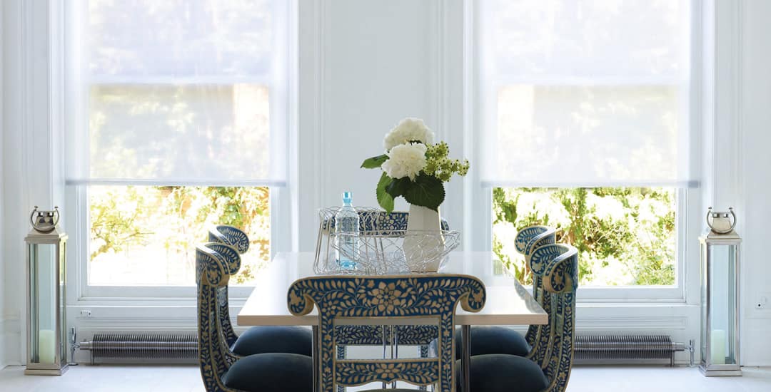 White sheer roller blinds in dining room