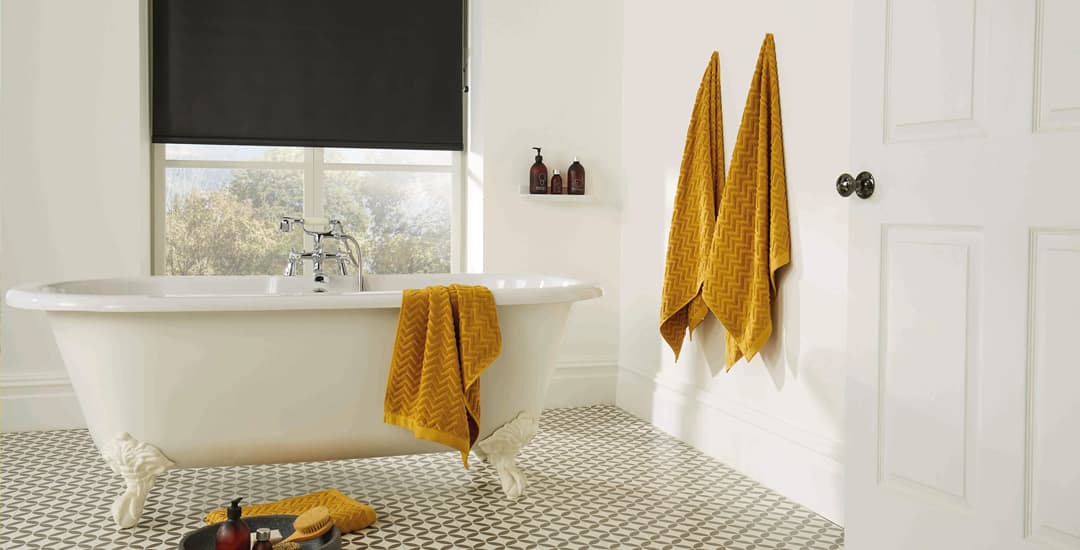 Black pvc roller blinds in cream bathroom 