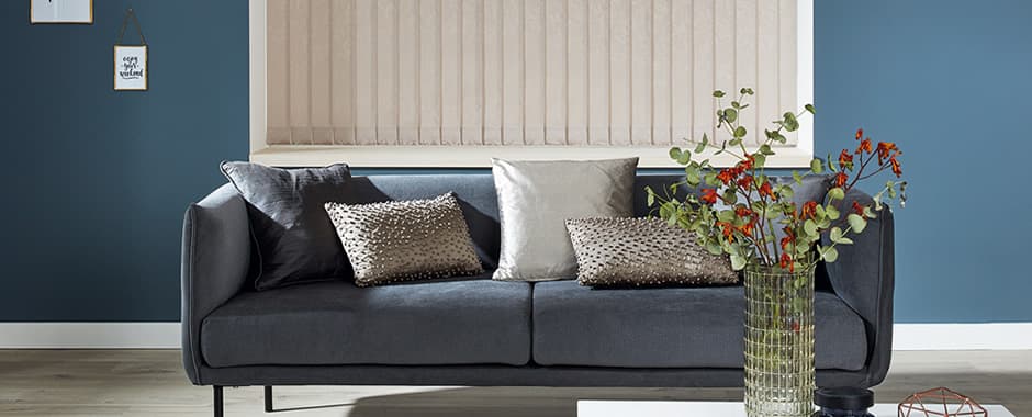 Closed beige vertical blinds in blue lounge