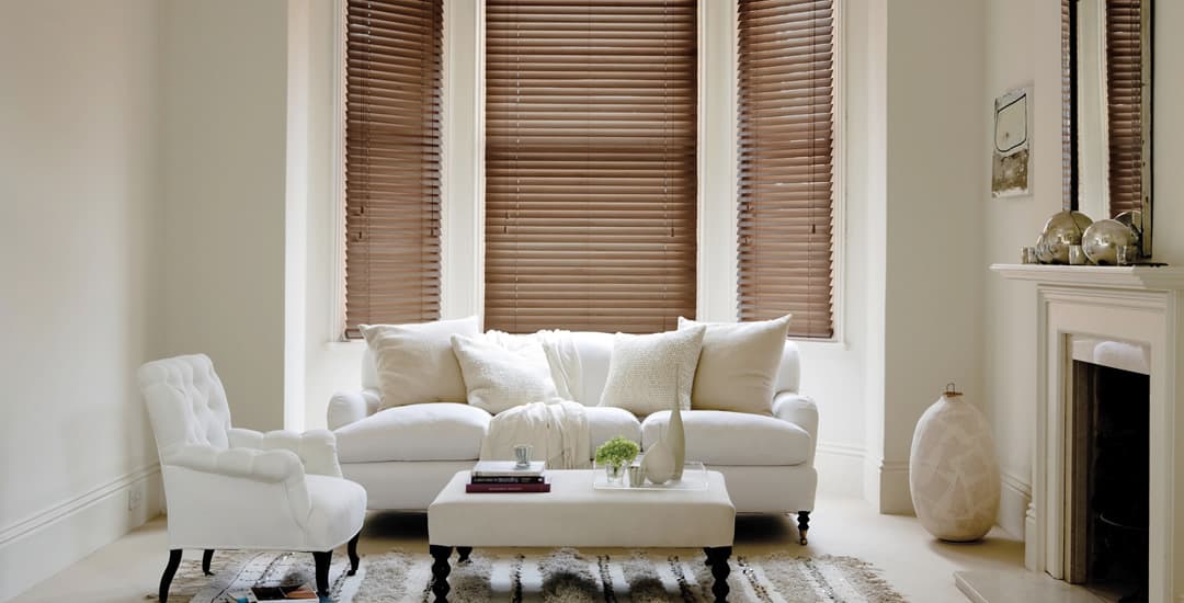 Closed real wooden blinds in lounge bay window