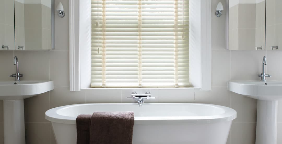 Cream faux wood blinds with tapes in bathroom