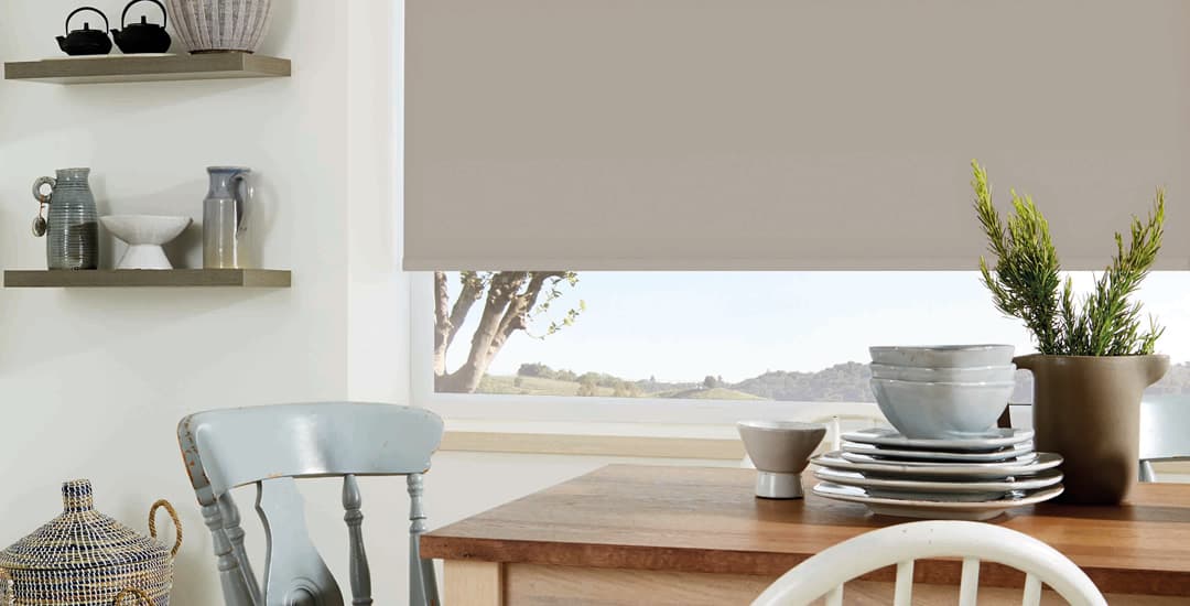 Plain brown roller blind in dining room