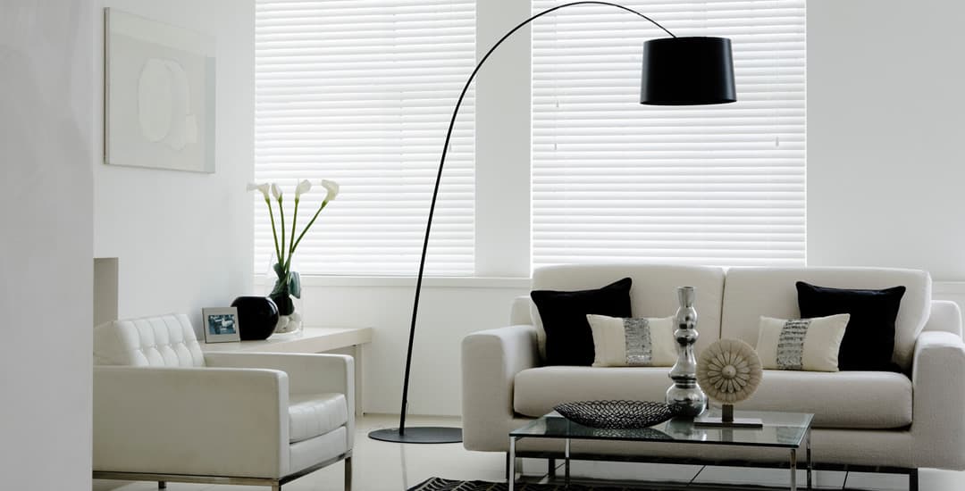 White faux wood blinds in living room