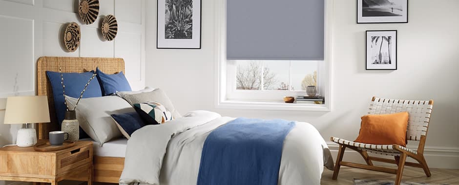 Grey thermal blackout roller blinds in bedroom