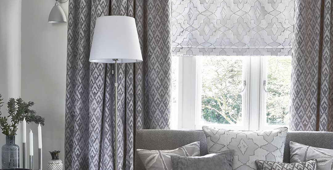 Silver roman blinds inside the recess and curtains outside