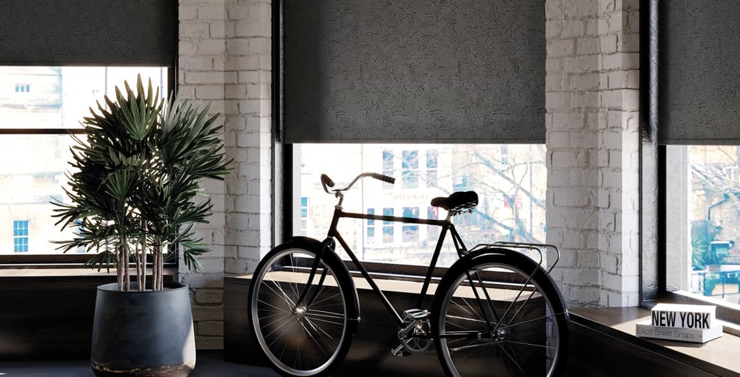 Black patterned roller blinds in apartment bay window