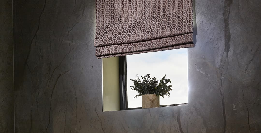 Brown geometric roman blind in bathroom 