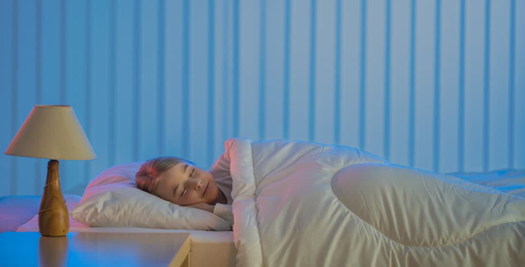 Girl asleep in bedroom with blinds