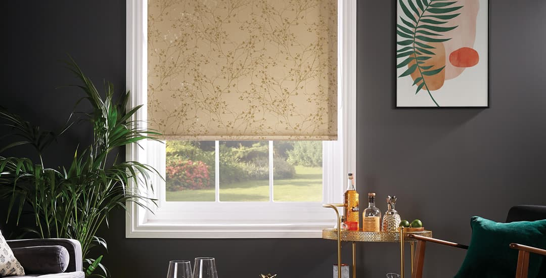 Gold floral roller blinds with light around the edges