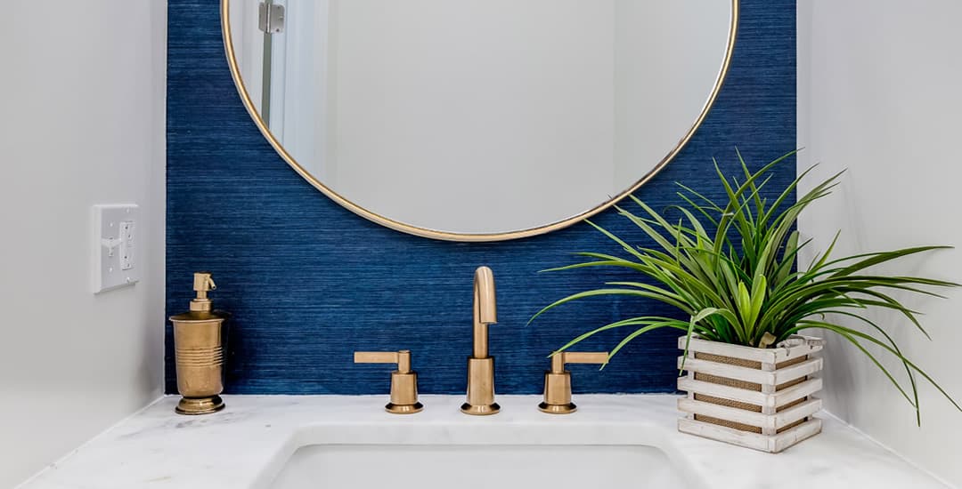 Large mirror in small blue and white bathroom