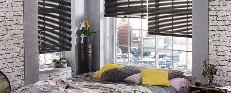 Black aluminium venetian blinds in bedroom