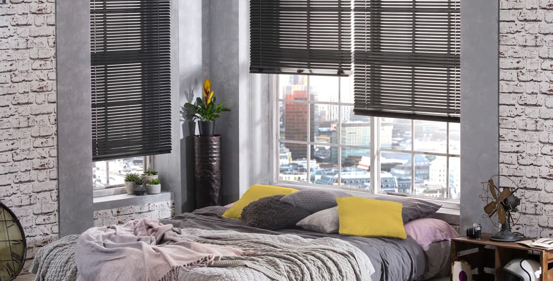 Black aluminium venetian blinds in bedroom