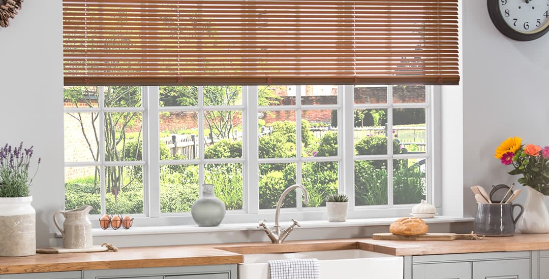 Brown aluminium venetian blinds in kitchen