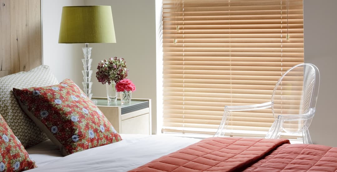 Closed light wood venetian blind in bedroom