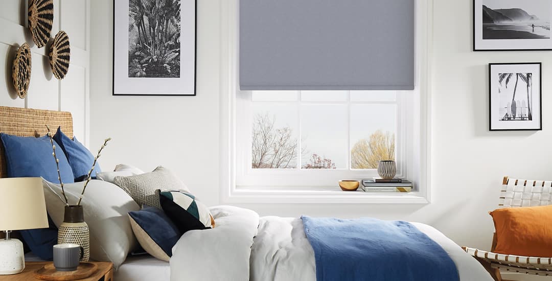 Grey thermal blackout roller blinds in bedroom