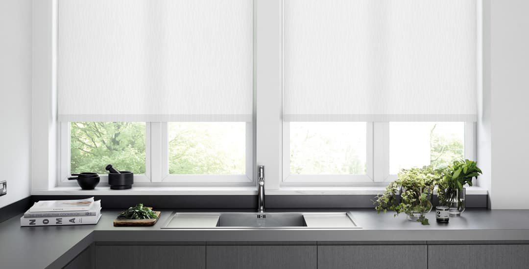 White roller blinds in white and grey modern kitchen