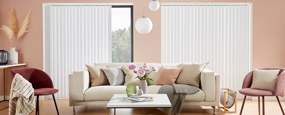 White vertical blinds in peach living room