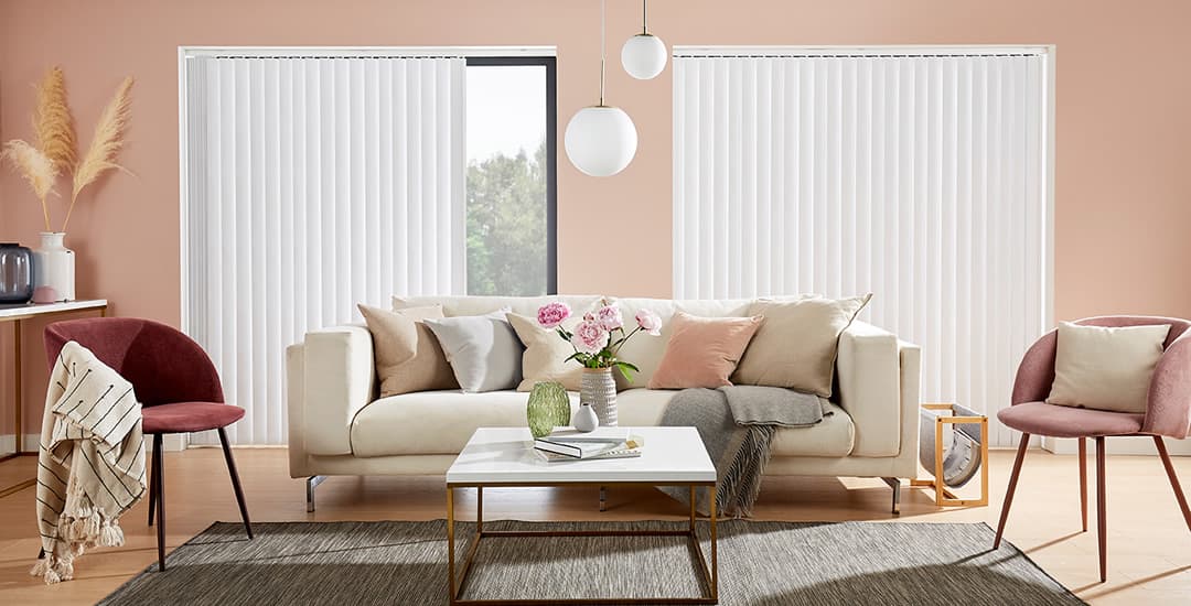White vertical blinds in peach living room