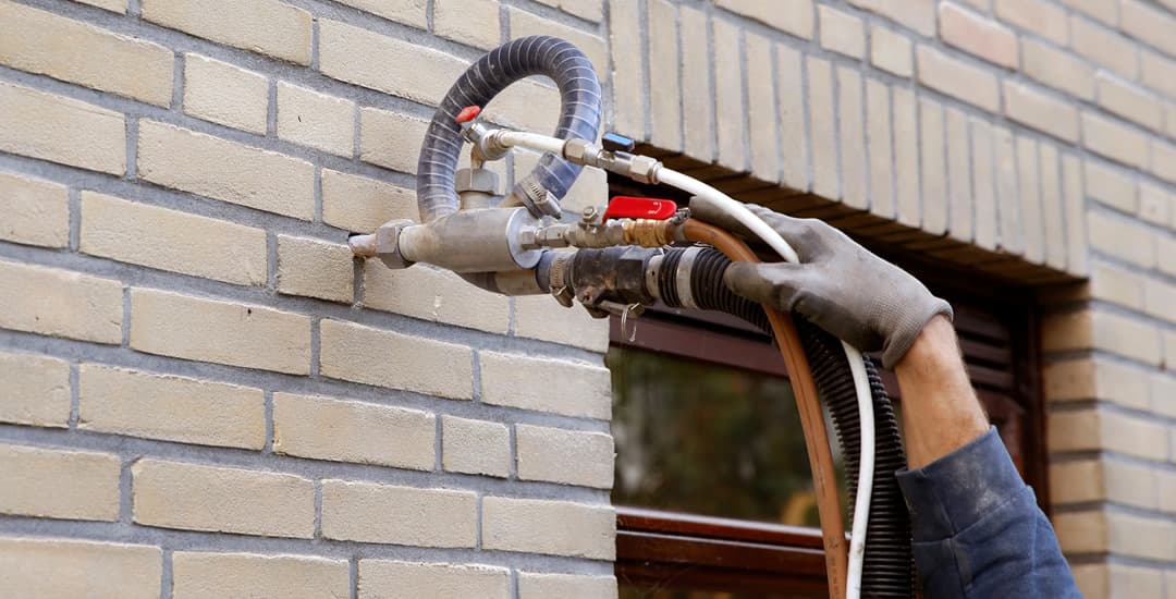 Cavity wall insulation being installed 