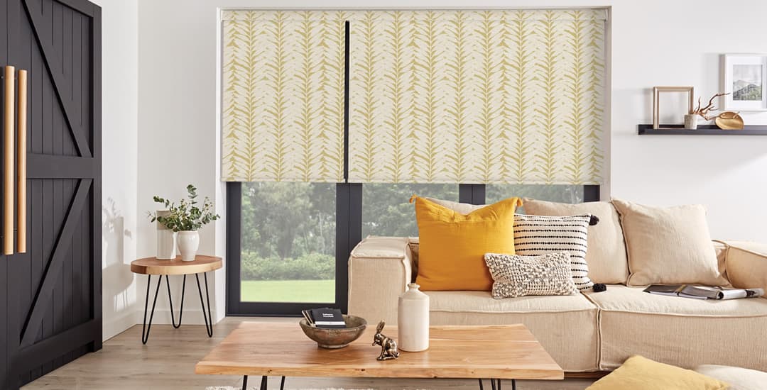 https://www.englishblinds.co.uk/blog/wp-content/uploads/2022/04/ochre-leaf-patterned-blackout-roller-blinds-in-living-room.jpg