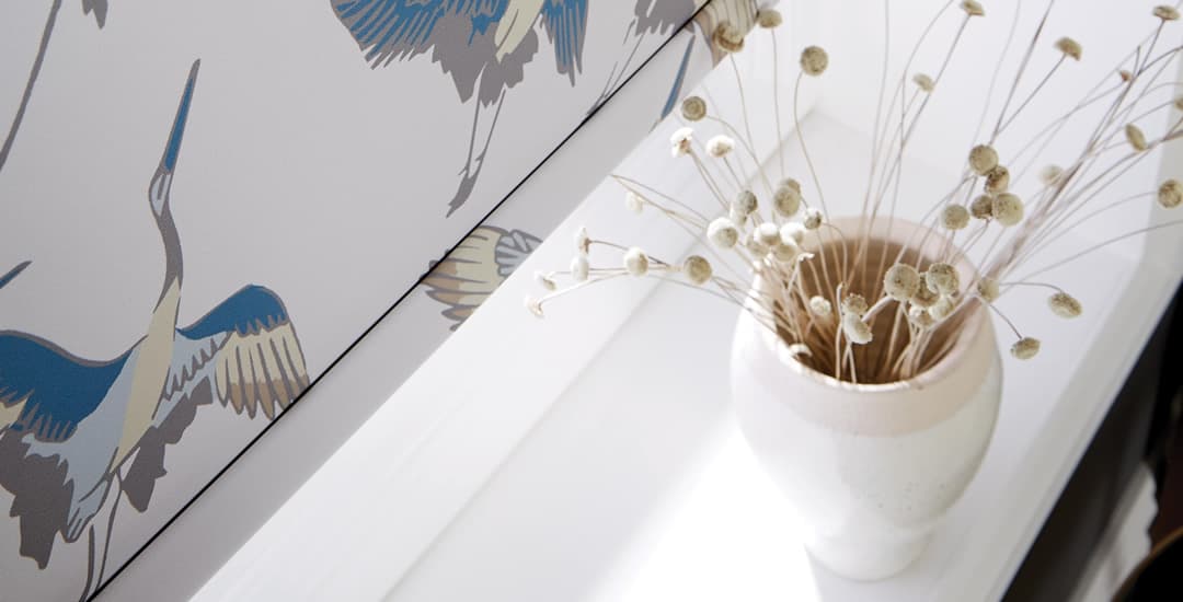 Patterned roller blinds nearly touching the windowsill