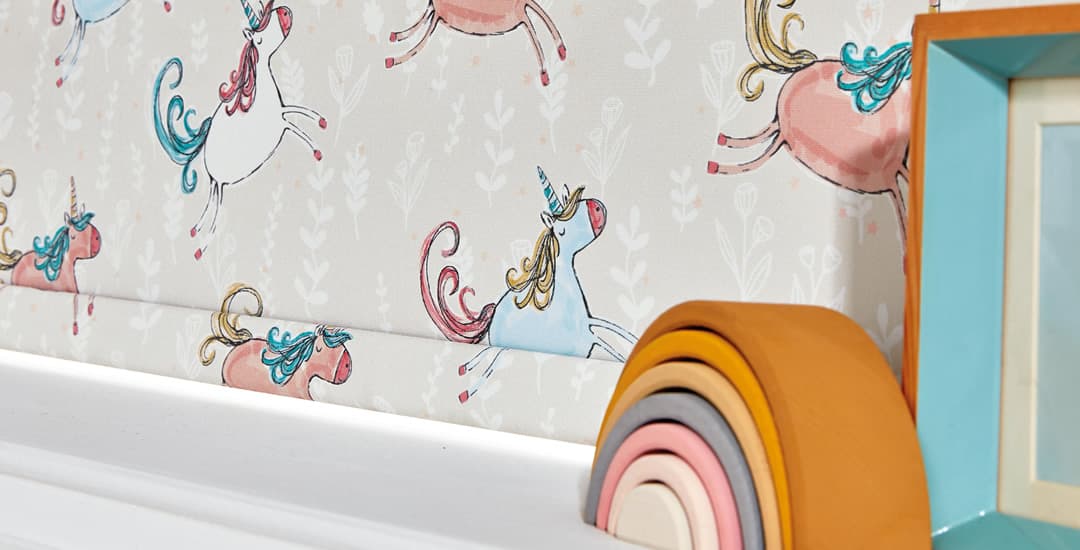 Unicorn patterned blackout roller blinds sitting on windowsill