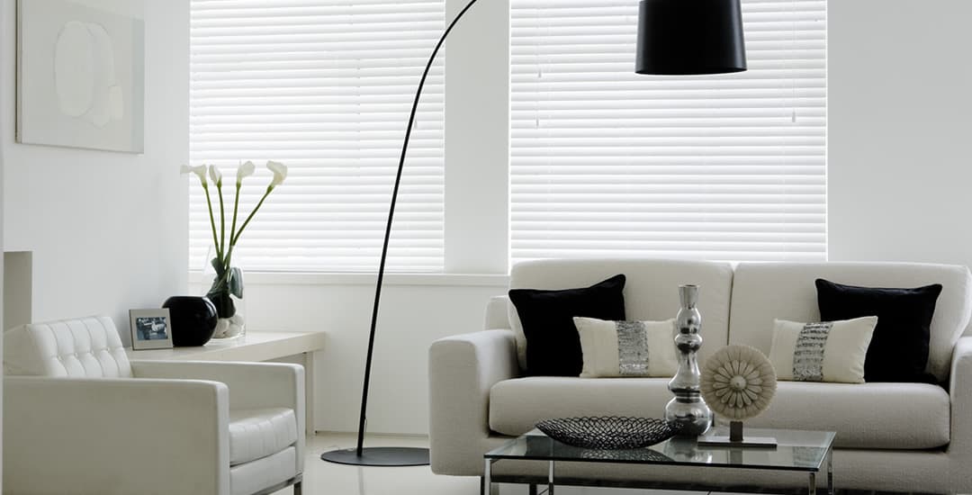 Closed white wooden blinds in living room