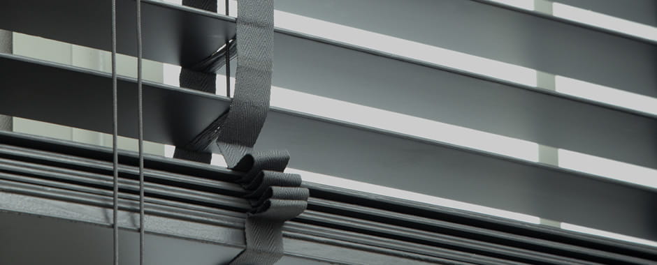 Closeup of black wooden venetian blinds slats