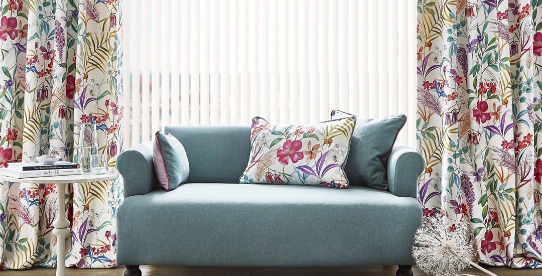 Floral curtains and white vertical blinds in lounge