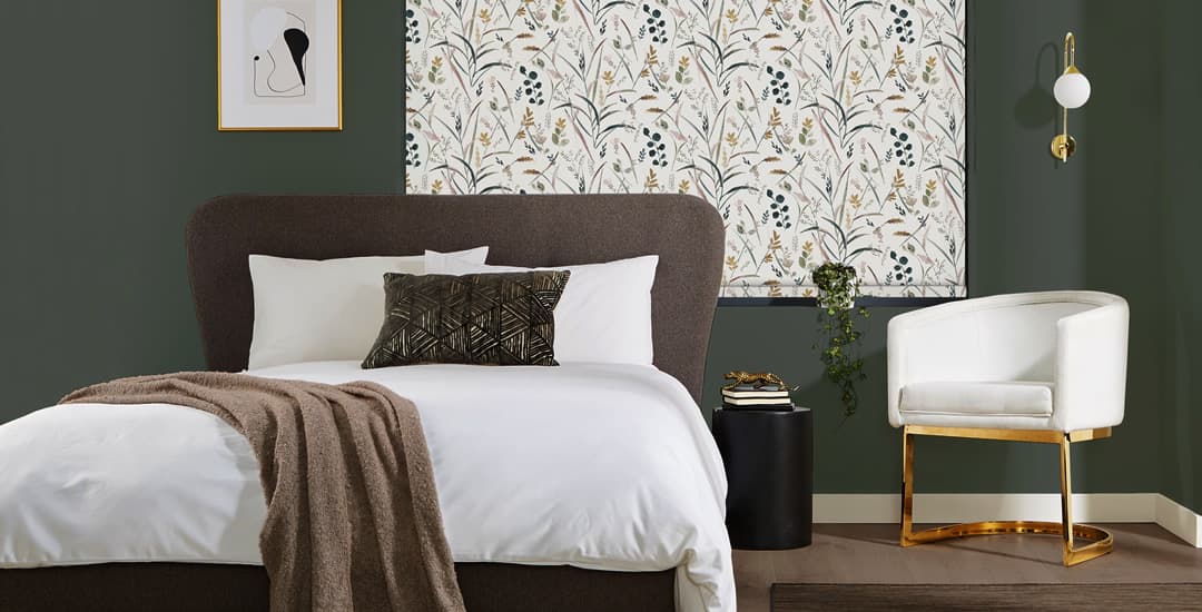 Floral patterned roller blinds closed at night in bedroom